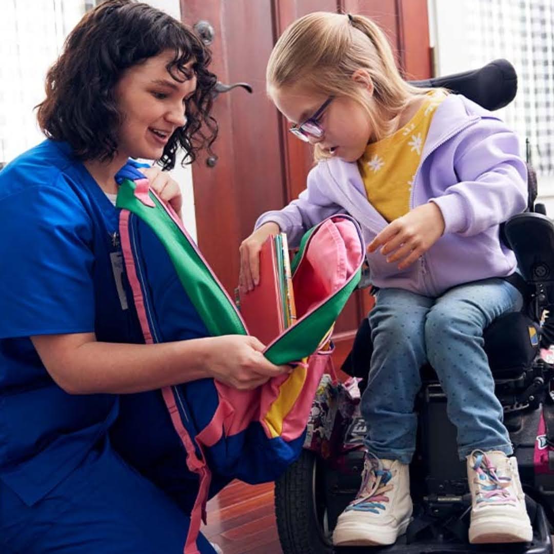 EMIC nurse caring for a child in a wheelchair at home