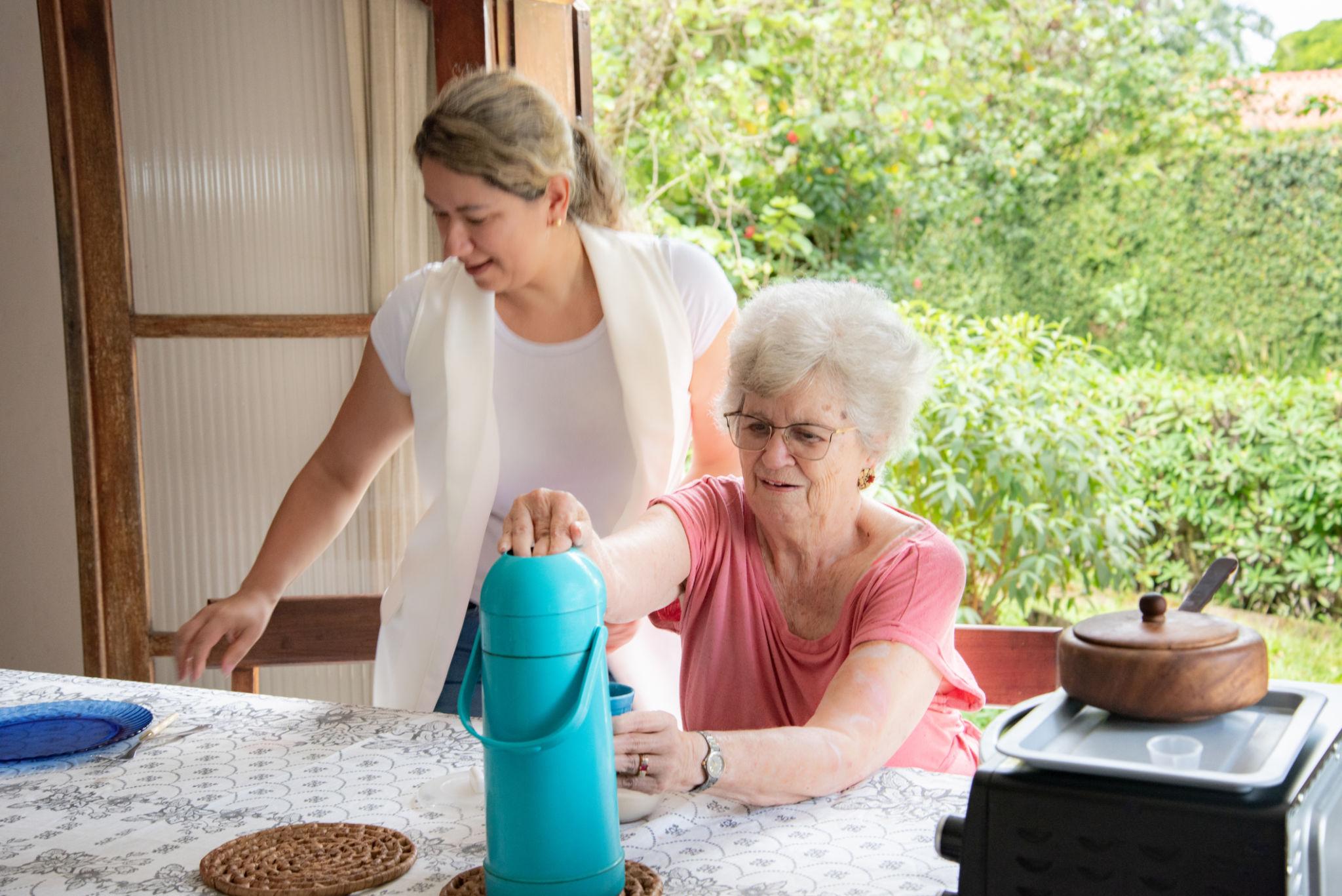Caregiver assisting a senior woman at home