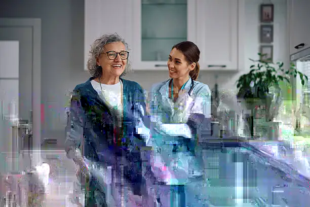Caregiver assisting a senior woman at home