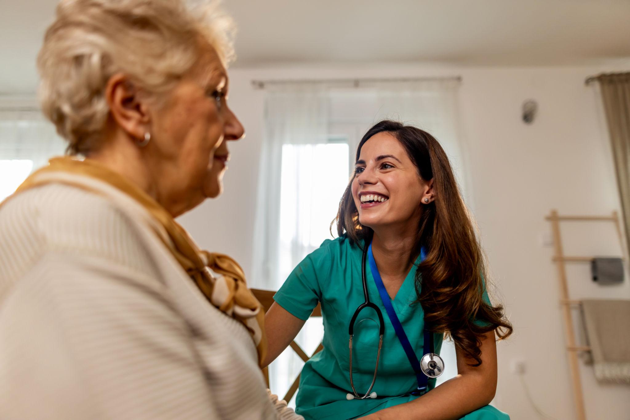 EMIC caregiver helping an elderly woman at home